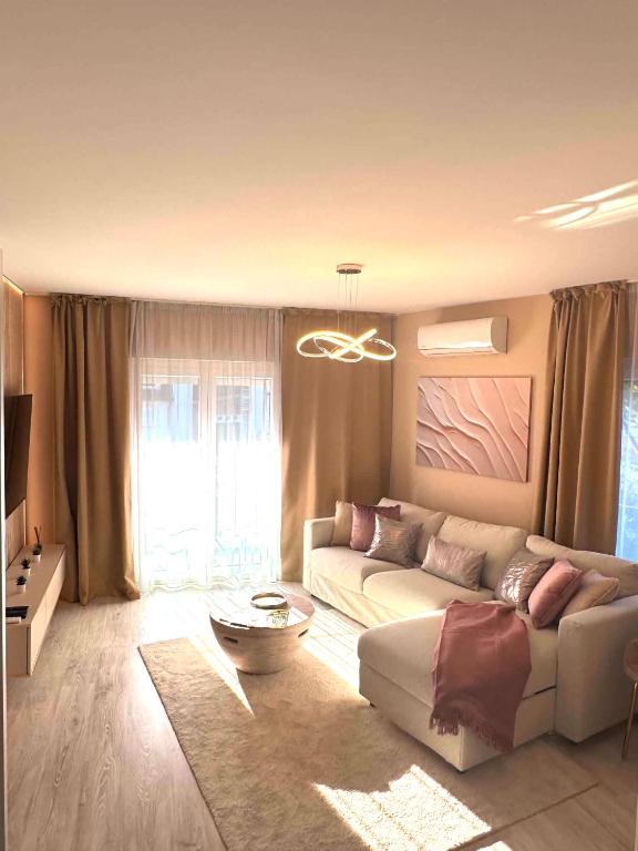 a living room with a couch and a table at Luxiva Home in Nyíregyháza