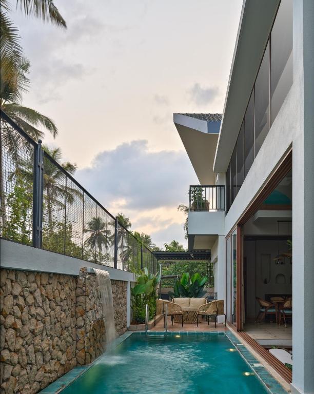 a swimming pool in the backyard of a house at The Roaring Pines in Dhikuli