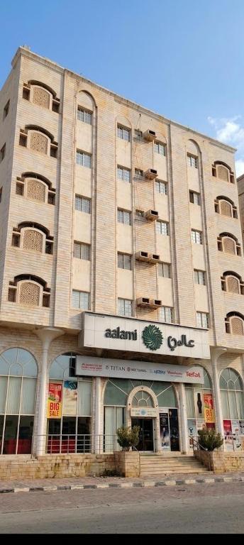 a large building with a store in front of it at الفردوس - RED14 Al-Firdous in Salalah