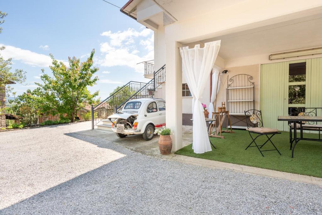 a white car parked on the side of a house at Casa Corniolo Near Arezzo in Monte San Savino