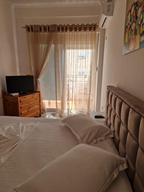 a bedroom with a large bed with a window at Villa Noah in Berat