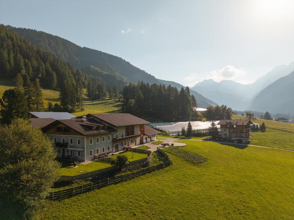 an aerial view of a house in a green field at Unterbergerhof - Escape daily life - Enjoy nature - Explore more with activeCARD Sterzing in Val di Vizze