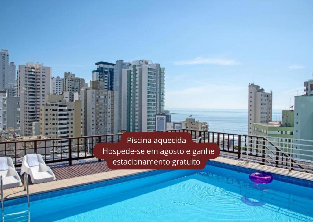 a swimming pool on the roof of a building at Atobá Praia Hotel by Pires - Balneario Camboriu in Balneário Camboriú