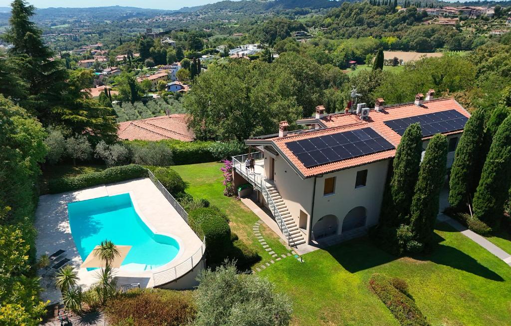 an aerial view of a house with solar panels on the roof at Sunset Serenity Villa in Padenghe sul Garda