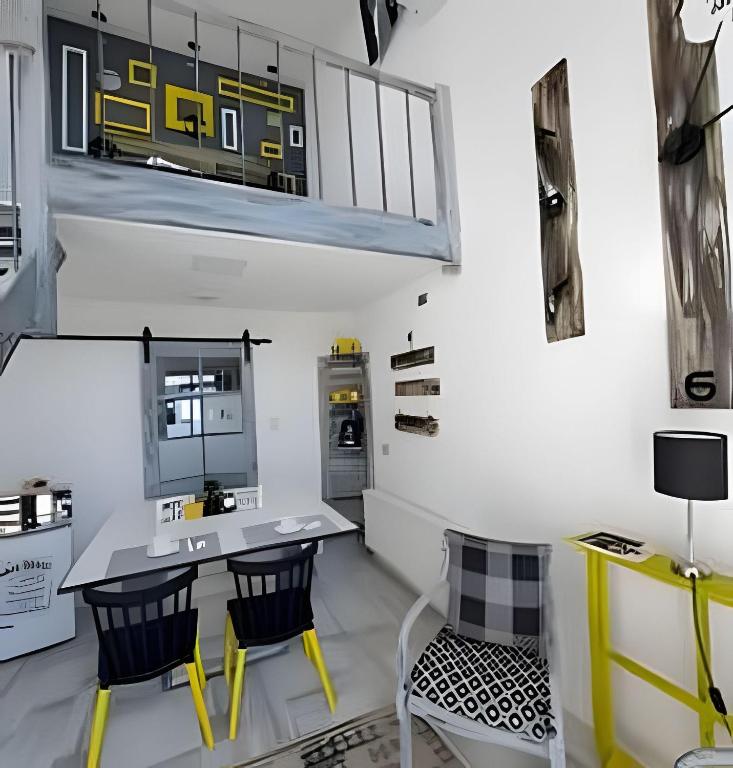 a room with a table and chairs and a train on the wall at 1 Comfortable loft with WiFi and central heating in Coihaique