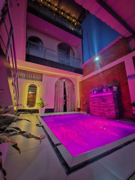 a room with a pool with pink lighting at Sol de sauce - Casa Vacation Stay in Sauce