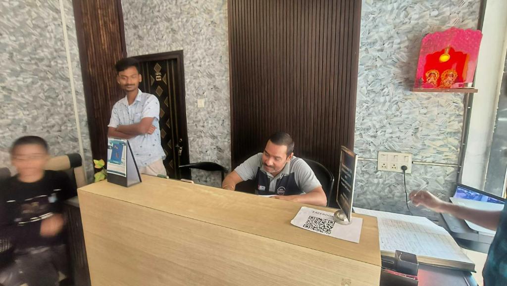 a man sitting at a counter in a restaurant at Hotel O Krishna Bhawan in kolkata