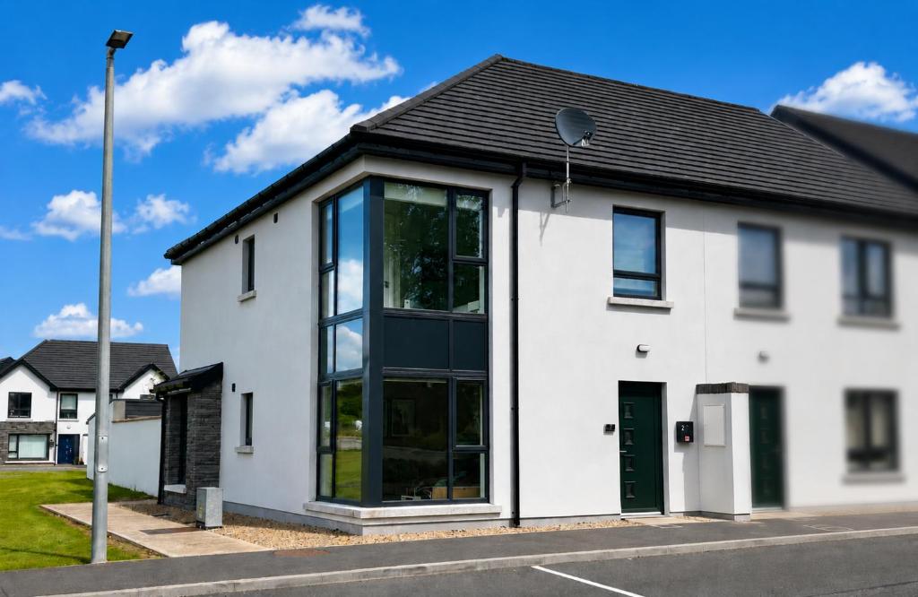 a white house with a black roof at No2 WestPoint Donegal Town in Donegal