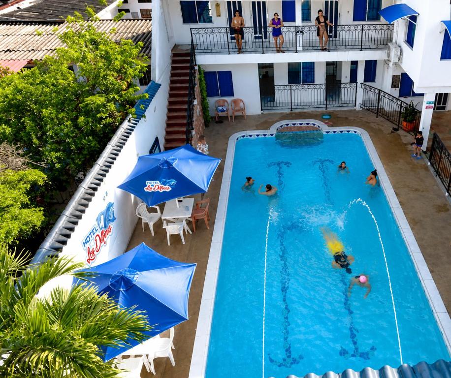 an overhead view of a swimming pool with people in it at Hotel Los Delfines Melgar in Melgar