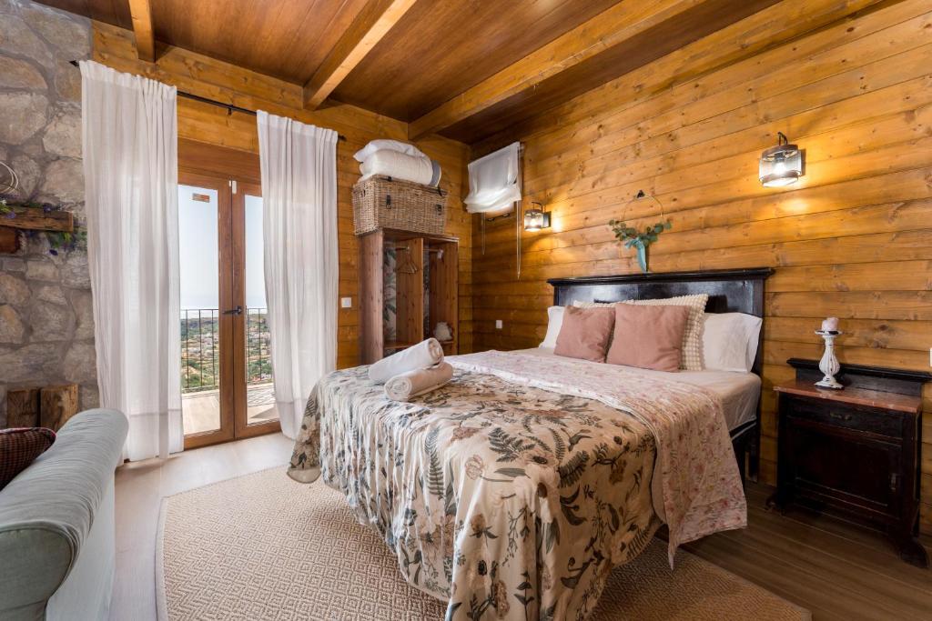a bedroom with a bed in a room with wooden walls at Ático FUENTE HERVERA in Vega de San Mateo