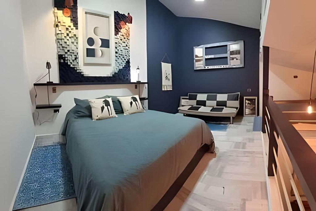 a bedroom with a large bed and a couch at 2 Family Lofts + central heating + comfort in Coihaique