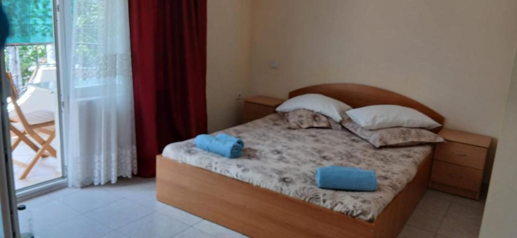 a bedroom with a bed with two blue boxes on it at Vila Angeli in Techirghiol