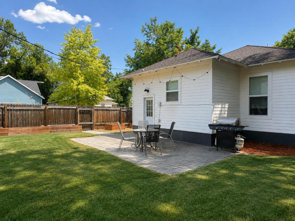 a backyard with a ping pong table and chairs at Cozy Chic Home In Downtown Loveland! in Loveland