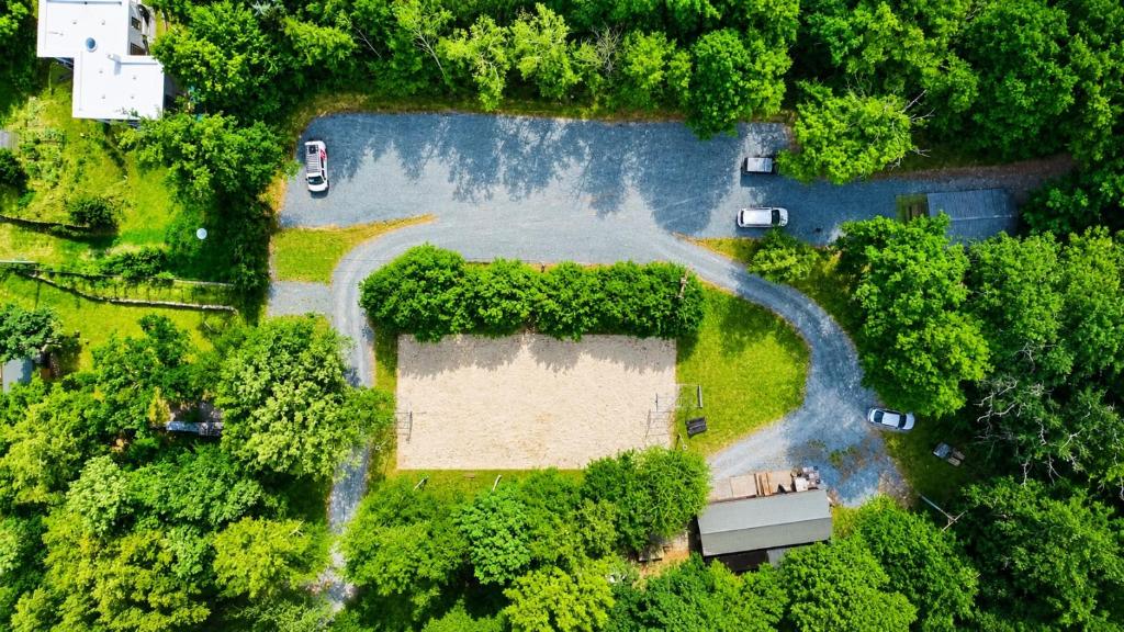 an aerial view of a park with trees and a road at Basecamp Brno in Brno
