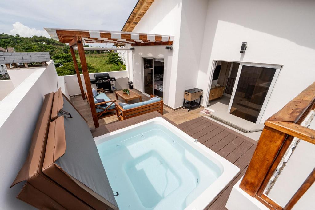 a swimming pool on the roof of a house at Rooftop Penthouse Jacuzzi, 2 Pools Playa Popy 500m in Las Terrenas