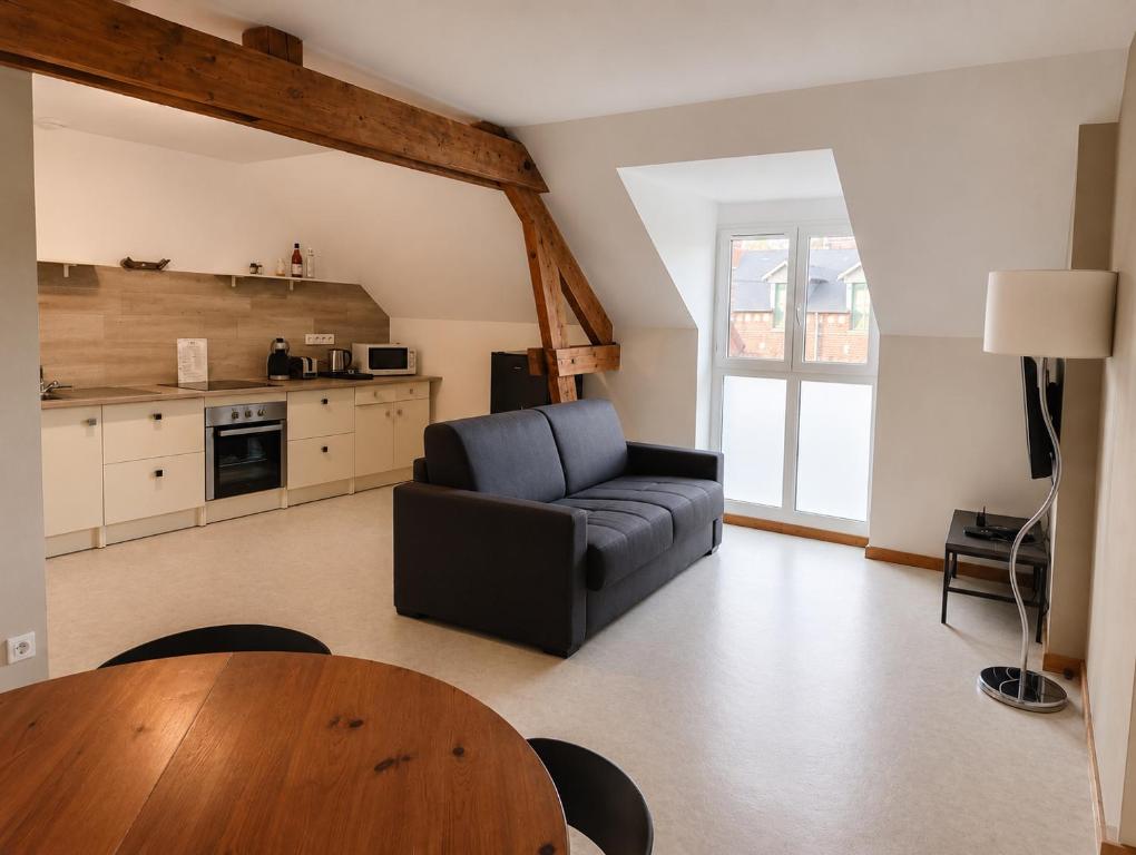 a living room with a couch and a table at La Clef des vignes 4 in Roye