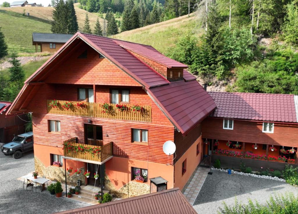 an aerial view of a building with red roof at Casa Răzvan in Arieşeni
