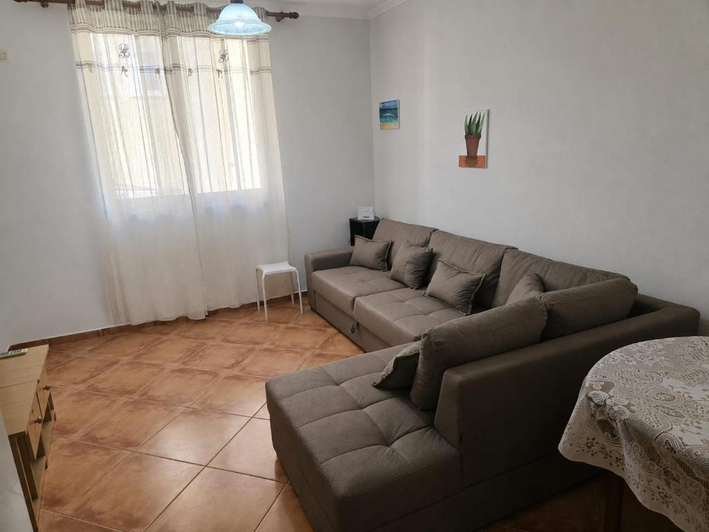 a living room with a couch and a table at APP Apartament in Durrës