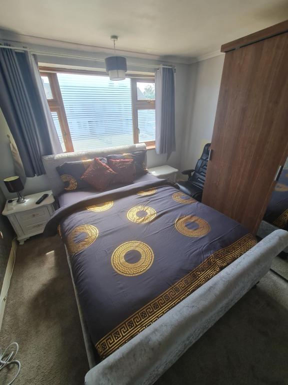 a large bed in a bedroom with a large window at The Rose in Grays Thurrock