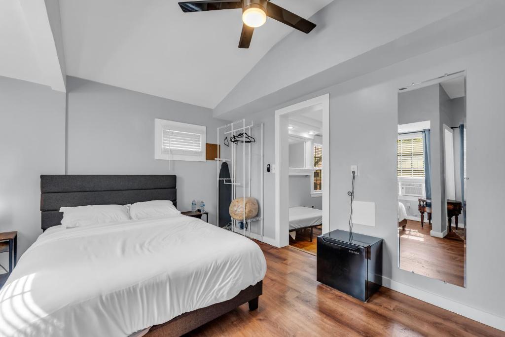 a bedroom with a white bed and a ceiling fan at Stay with Jay - Quinta Suite in Cleveland