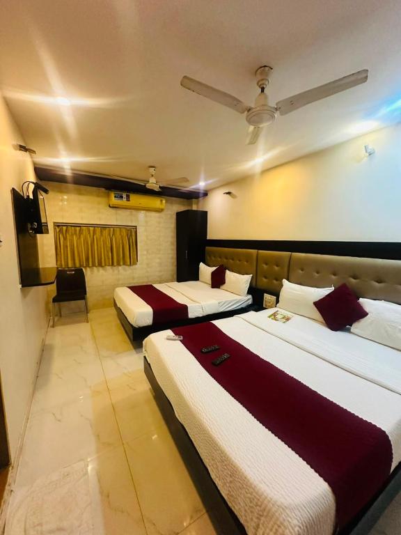 a hotel room with two beds in a room at Hotel Bkc Palace Kurla in Mumbai