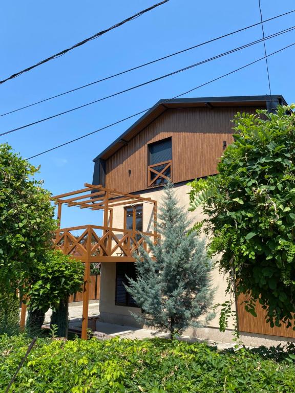 a house with a wooden facade at Apartmani Dora in Mataruška Banja