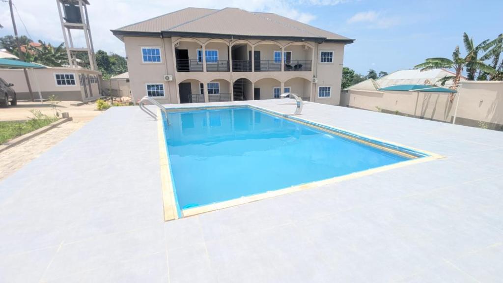 a swimming pool in front of a house at Solace Guest house in Buea