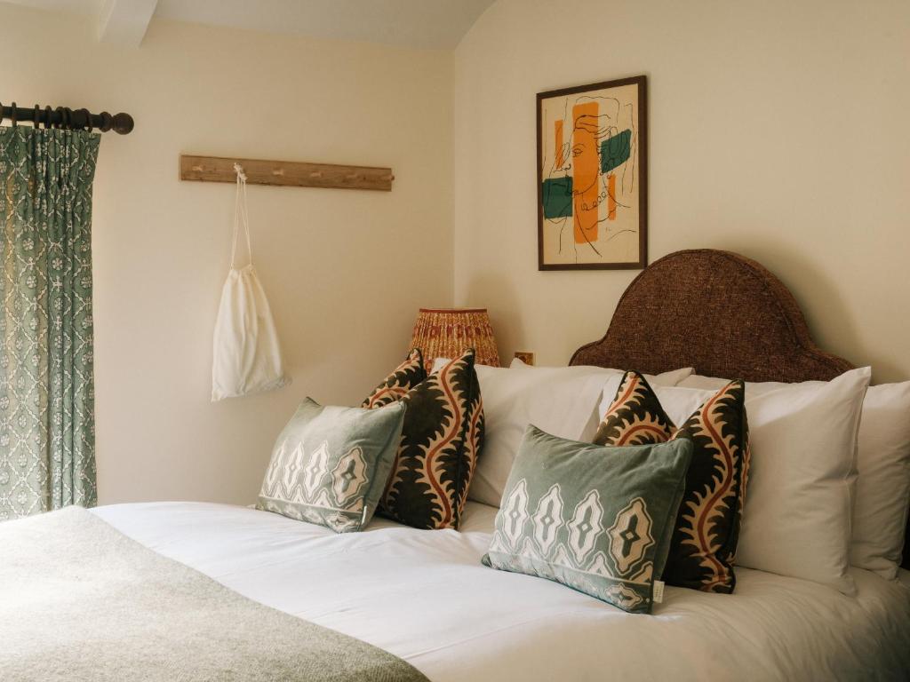 a bedroom with a white bed with pillows on it at The Great Decoy in Hurstbourne Tarrant