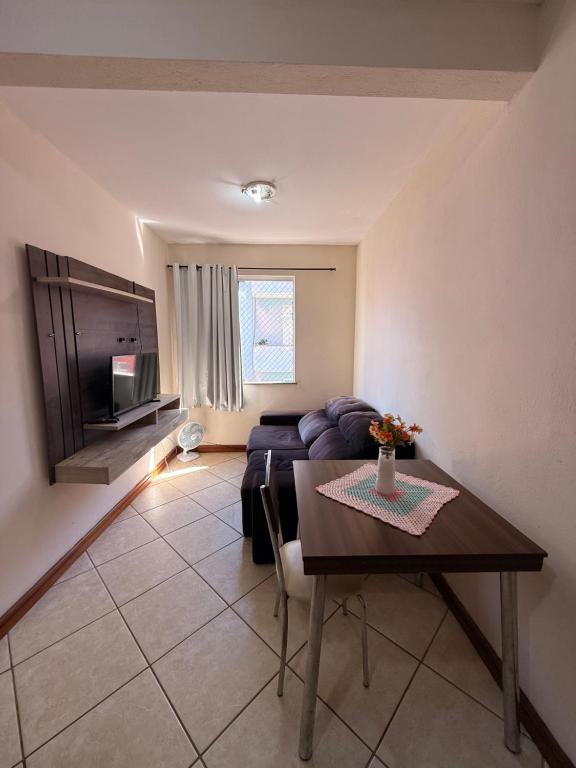 a living room with a couch and a table at Temporada Ilhéus Centro in Ilhéus
