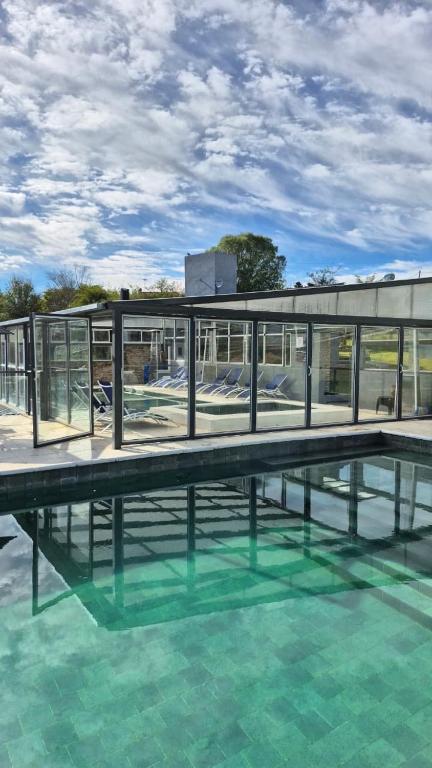 a building with a pool of water in front of it at El Palmar in San Antonio de Arredondo