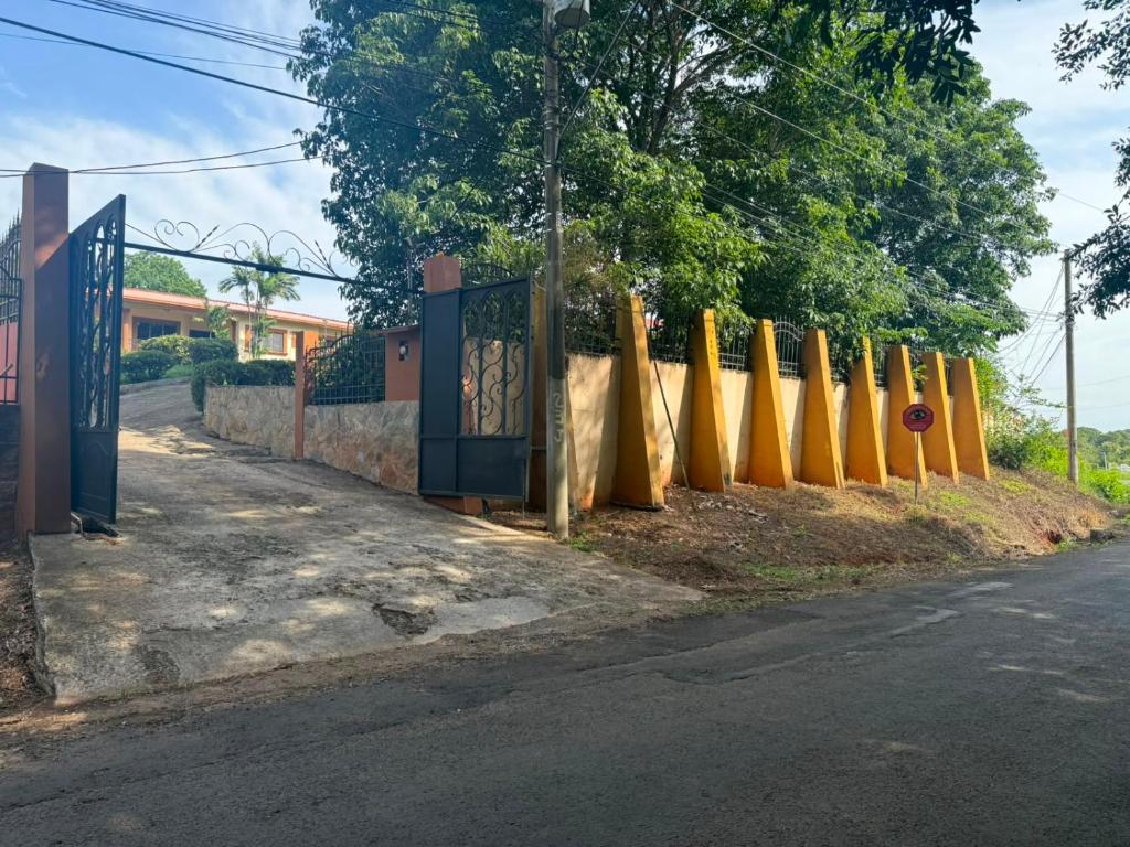 a fence with yellow surfboards on the side of a road at Mansion Sublime in Chitré