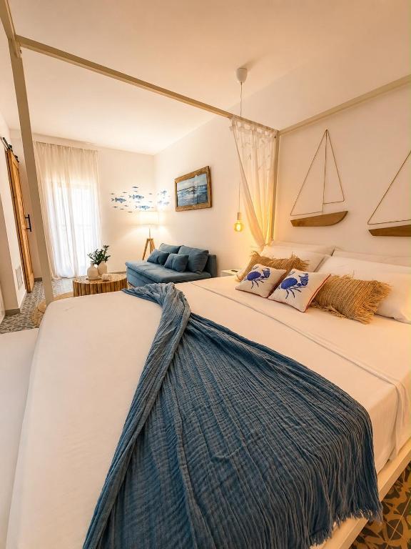 a bedroom with a large bed in a room at Le Tartarughe - Rooms and Apartments - in Milazzo