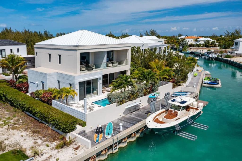 an aerial view of a house with a boat in the water at Second Wind Villa in Long Bay Hills