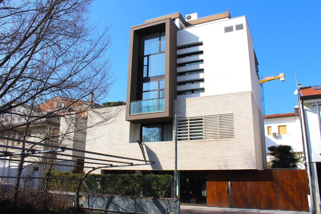 a house with a large window on the side of it at Residenza Nervesa in Lignano Sabbiadoro