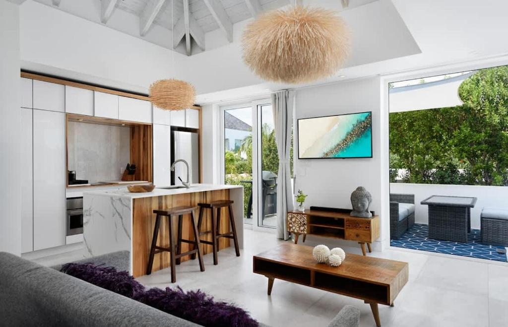 a kitchen and living room with a couch and a table at Ocean Dream Studio Blue - Ocean View in Long Bay Hills