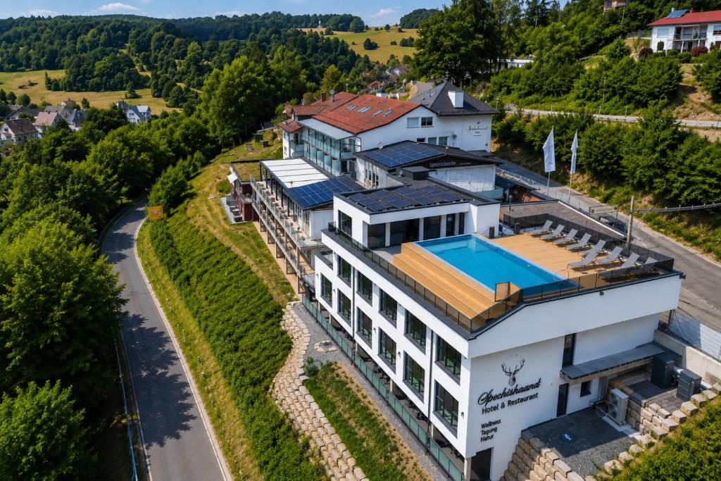 an aerial view of a house with a swimming pool at Hotel Spechtshaardt in Rothenbuch