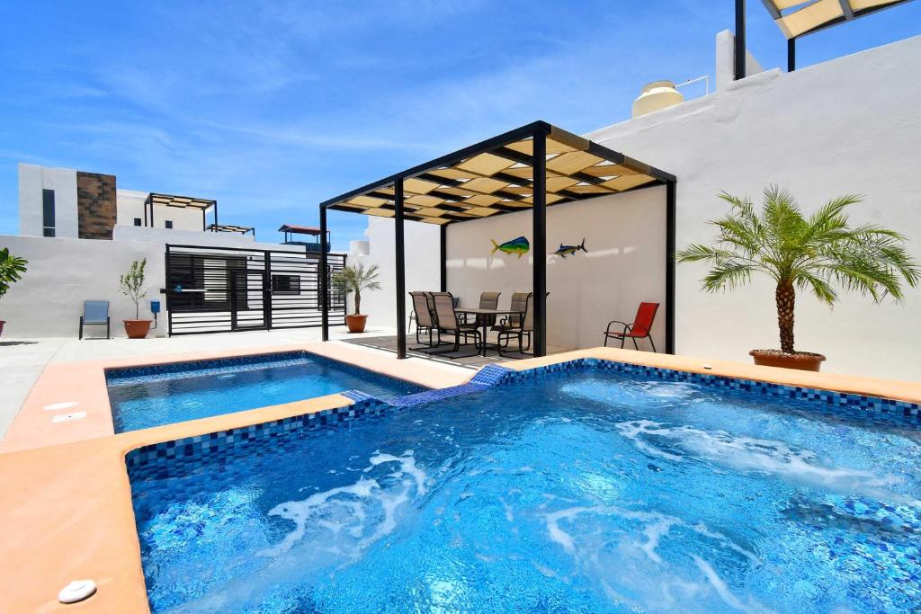 a swimming pool in the backyard of a house at 3BR House with Pool & Rooftop Terrace in El Centenario