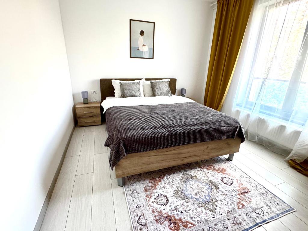 a bedroom with a large bed and a rug at The Nest in Otopeni
