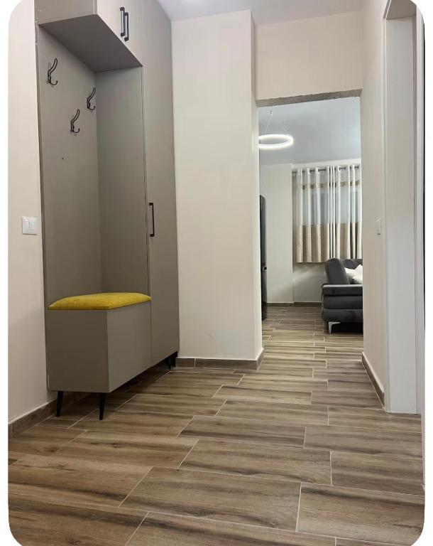 an office with a hallway with a chair and a couch at Ajans Apartament in Golem