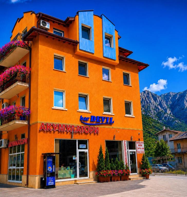 an orange building with a sign on it at Hotel Maria in Vratsa