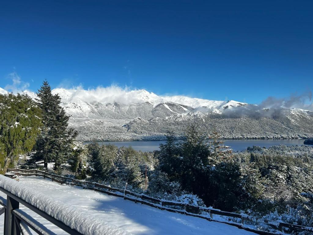 a view of a snow covered mountain and a lake at Estancia Del Carmen Mountain Resort in San Carlos de Bariloche