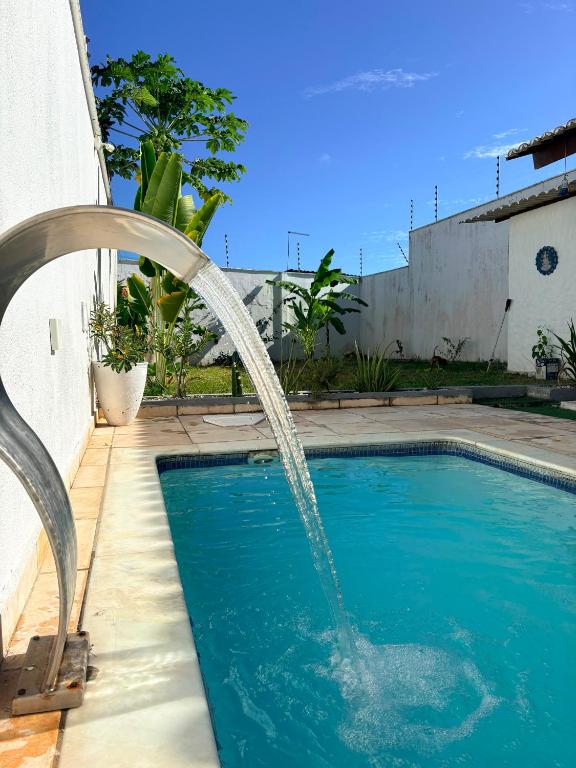 a swimming pool with a water fountain at Casa Macao Tibau do Sul in Tibau do Sul