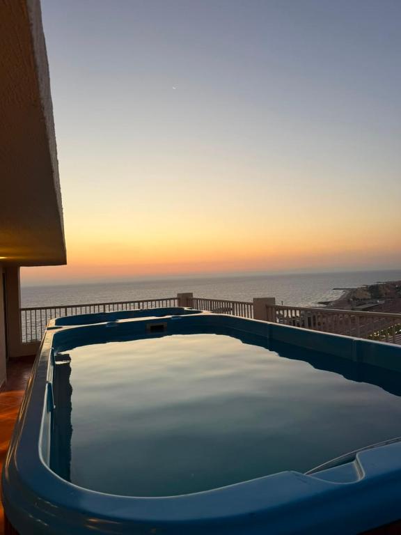 a swimming pool with a view of the ocean at Porto Sokhna Penthouse with Private Pool - MR in Ain Sokhna