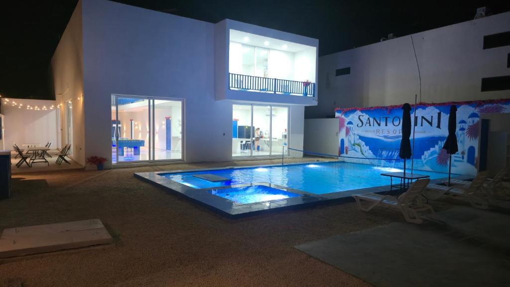a large swimming pool in the middle of a building at Santorini Resort in Mérida