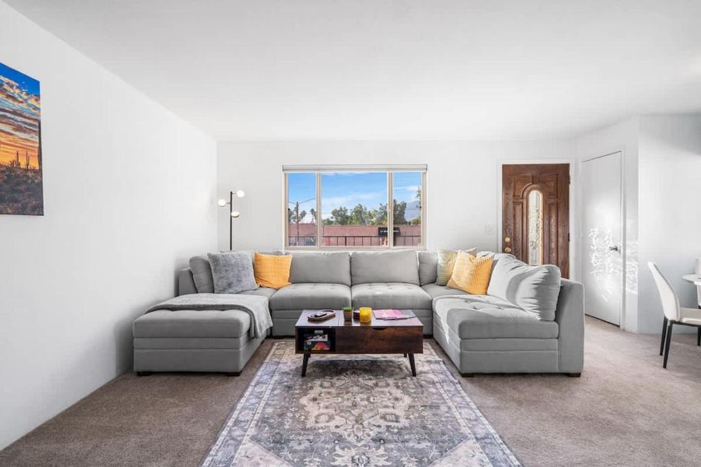 a living room with a couch and a table at Sunny & Bright Charm with Community Pool in Tucson