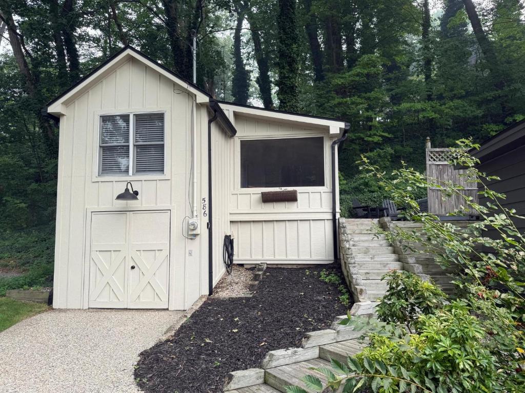 a white garage with a window and a door at The Oriole hot tub walk or Bike to Saugatuck in Saugatuck