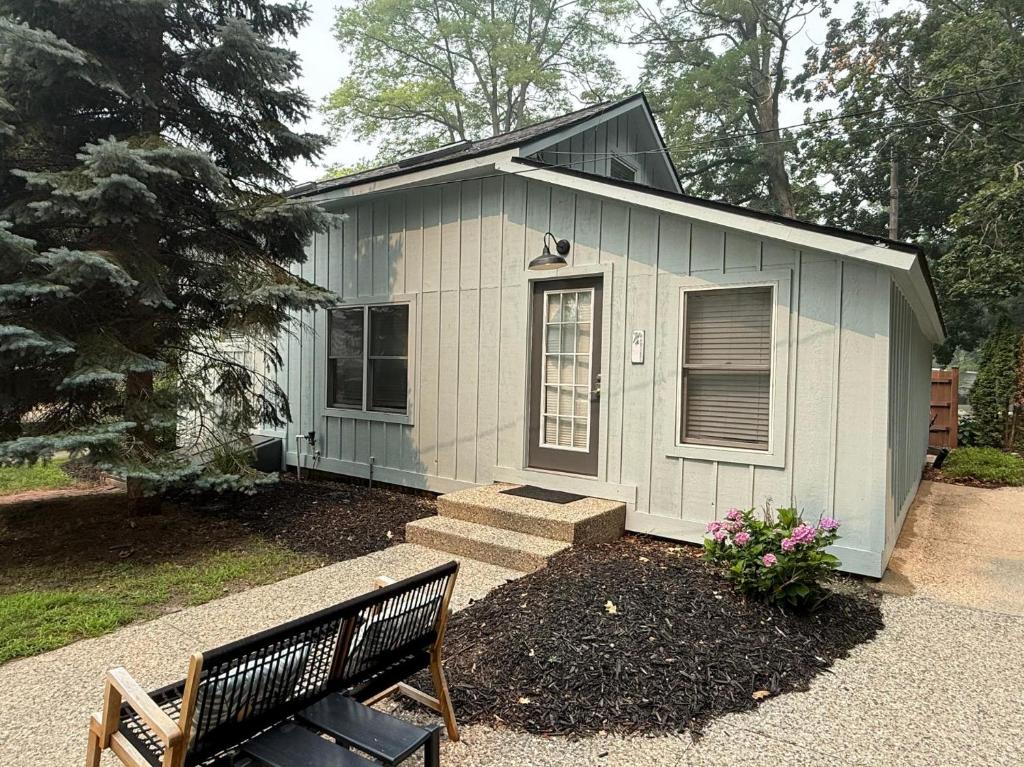 a small house with a bench in front of it at Hummingbird apt walk to Saugatuck in Saugatuck