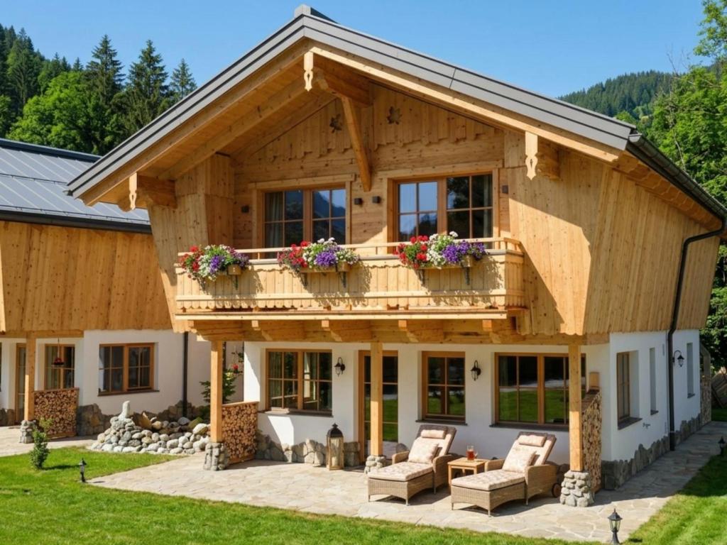 a log home with a deck and a patio at Wildrose in Wagrain