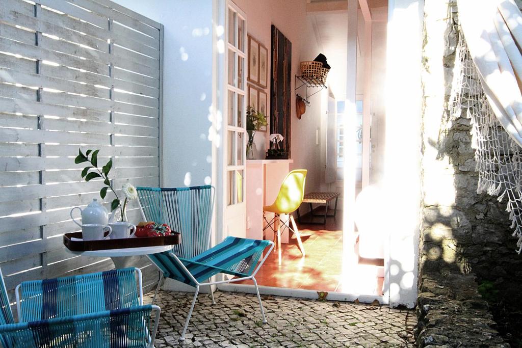 a patio with two chairs and a table on a patio at Senhora do Cabo Meco Homy Holidays in Sesimbra