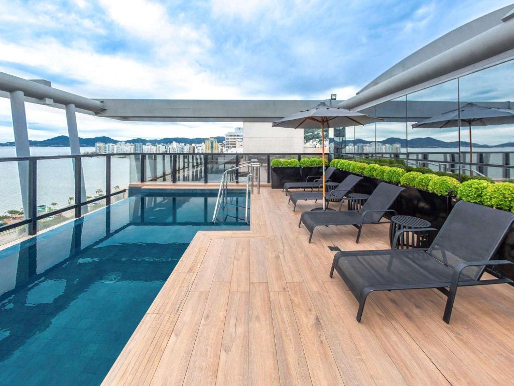 a swimming pool on the roof of a building at Novotel Florianopolis in Florianópolis